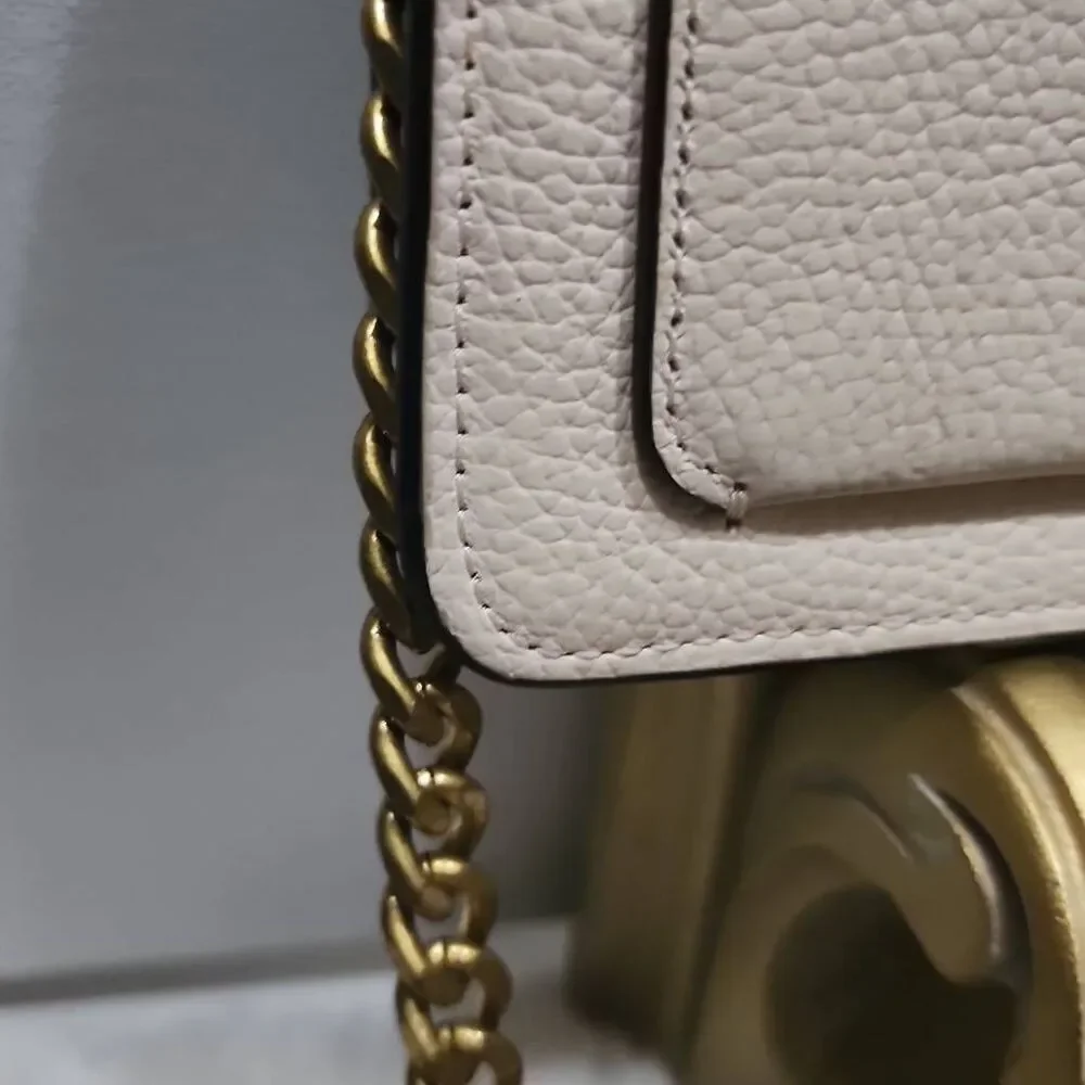 Coach Tabby Mini Chain Clutch in Chalk pebbled leather with gold-tone upgraded c